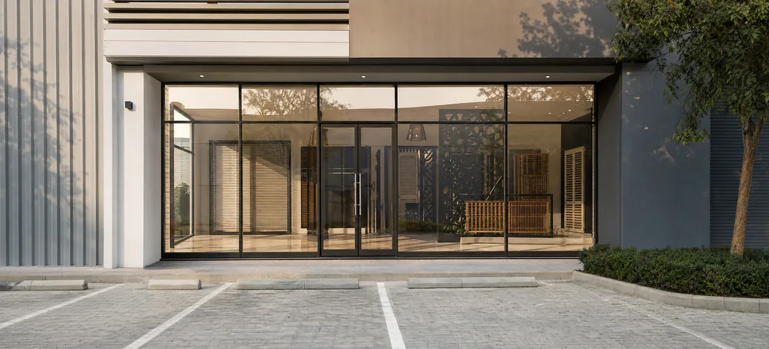 A showroom entrance with screen samples behind the glass