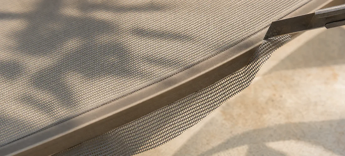 The excess mesh trimmed along the edge of the frame
