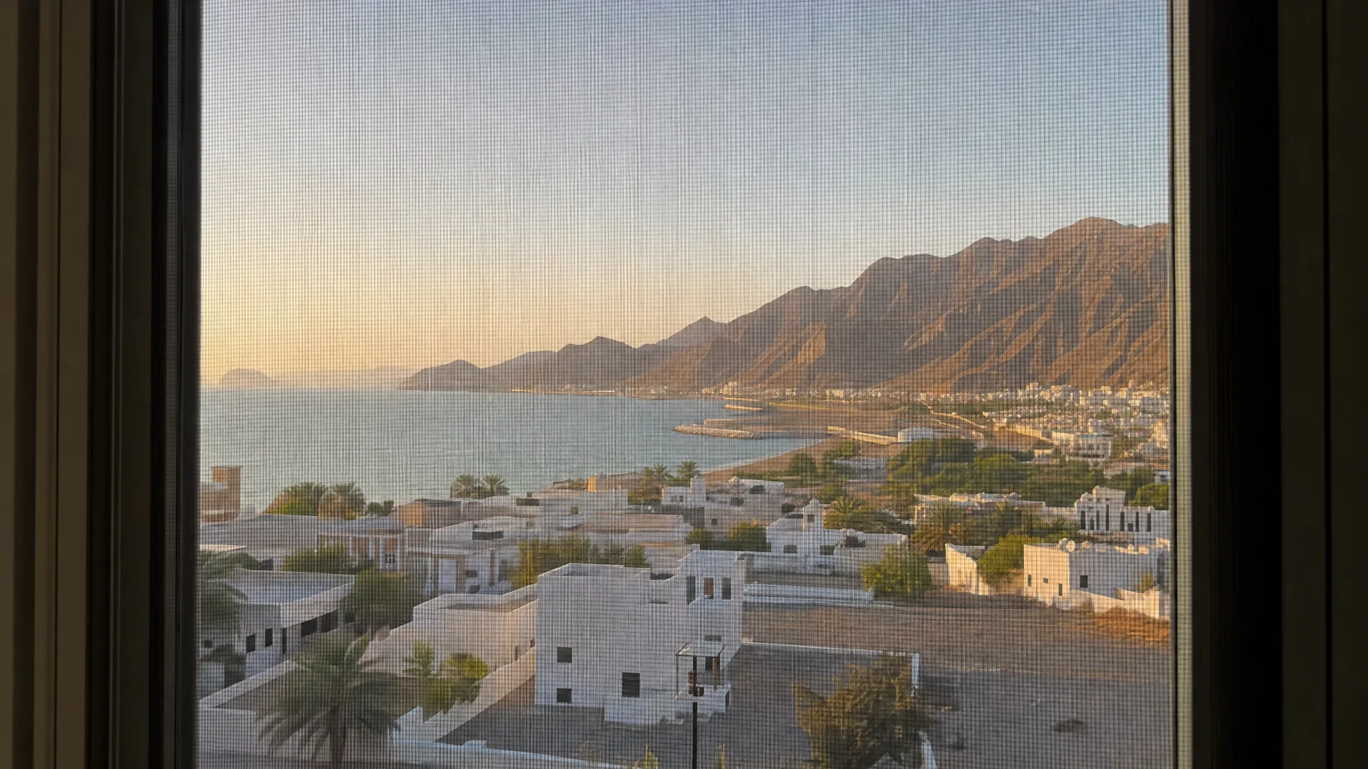 Typical Fujairah architecture with an insect screen on the window in front