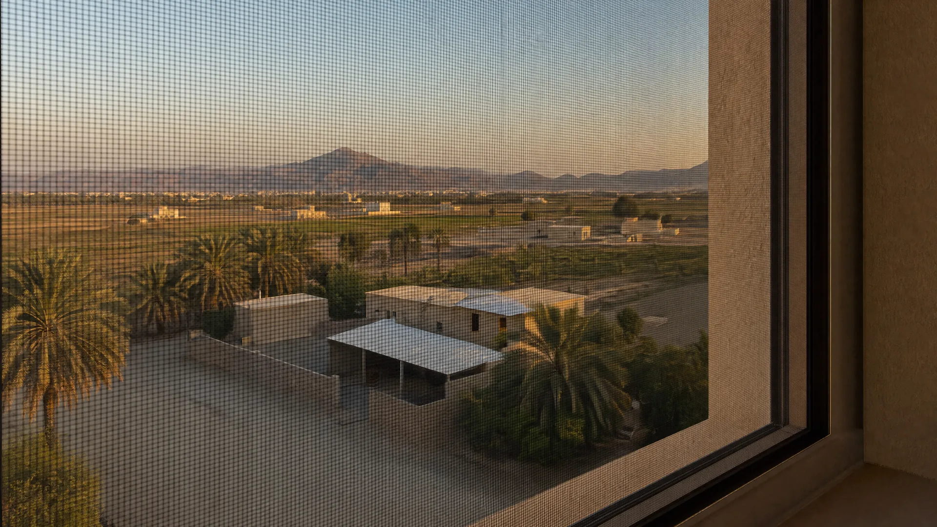 Typical Al Dhaid architecture with an insect screen on the window in front
