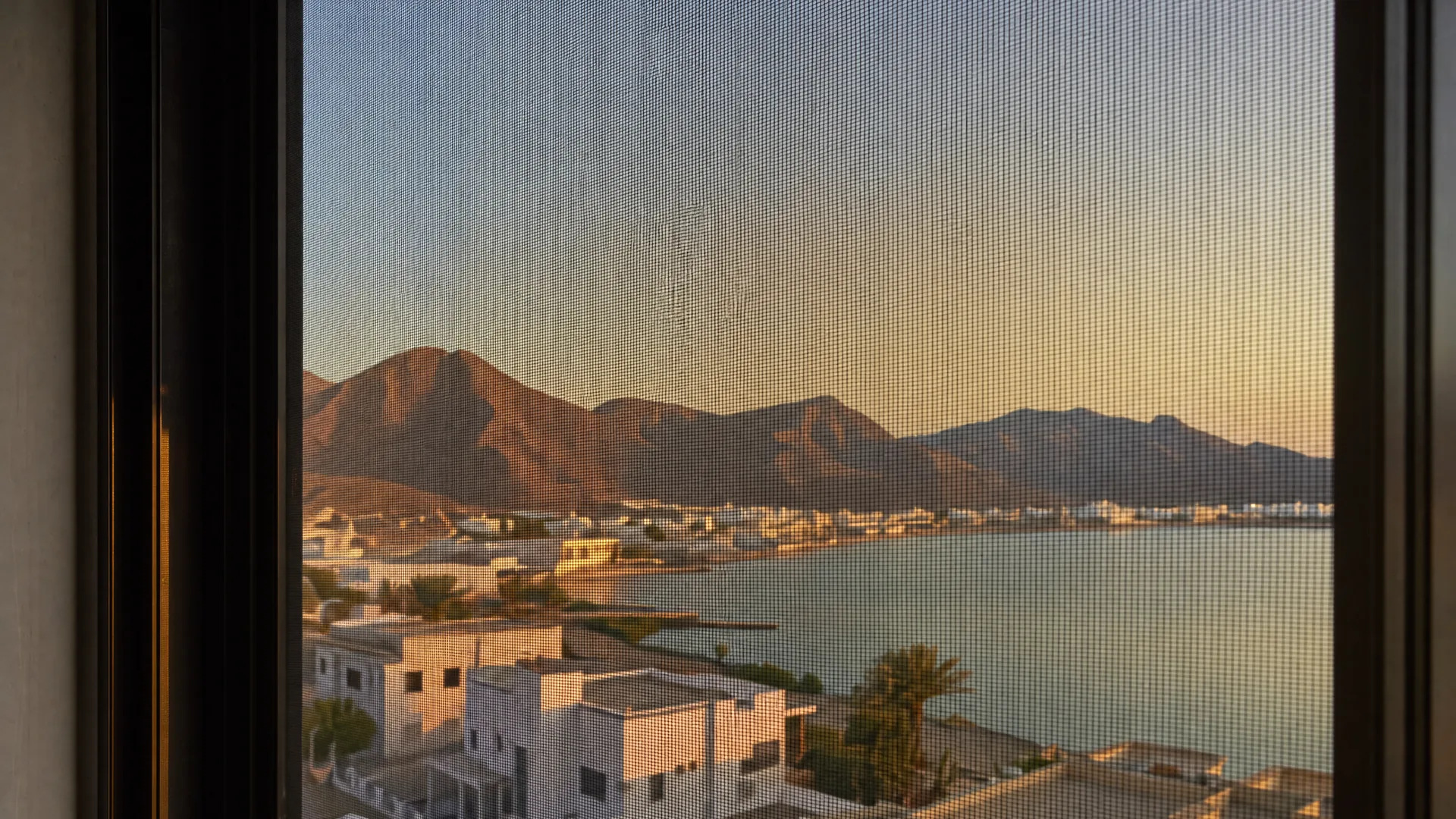 Typical Khor Fakkan architecture with an insect screen on the window in front